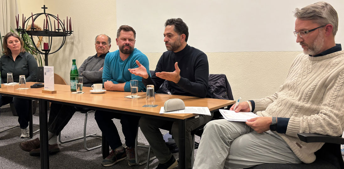 Elie Avidor und Sayel Jabareen sitzen an einem Tisch und berichten von ihren Erfahrungen
